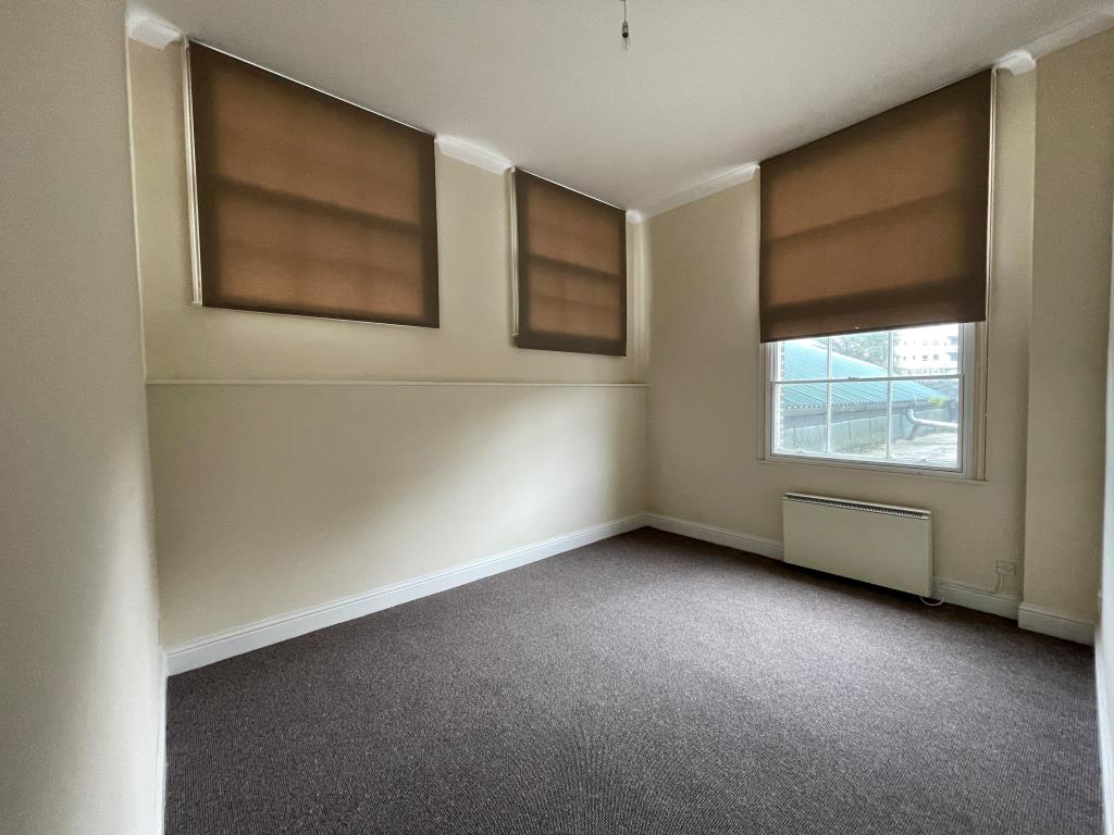Lot: 41 - VACANT TWO-BEDROOM FLAT - Bedroom with three windows and electric heating